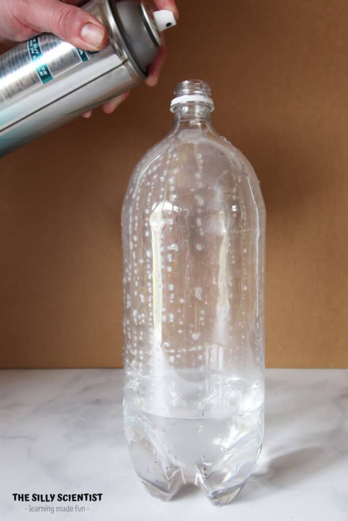 spray hairspray into bottle with water