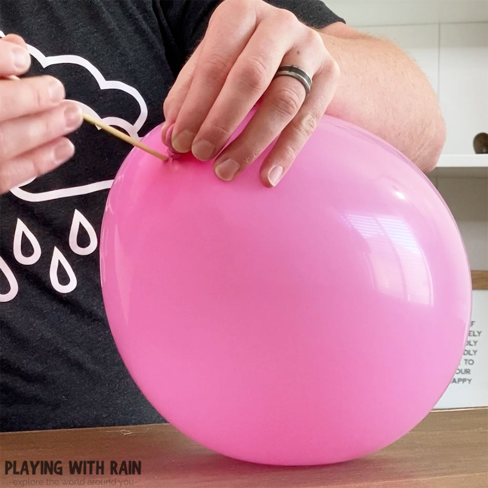 Insert a skewer into the top of the balloon