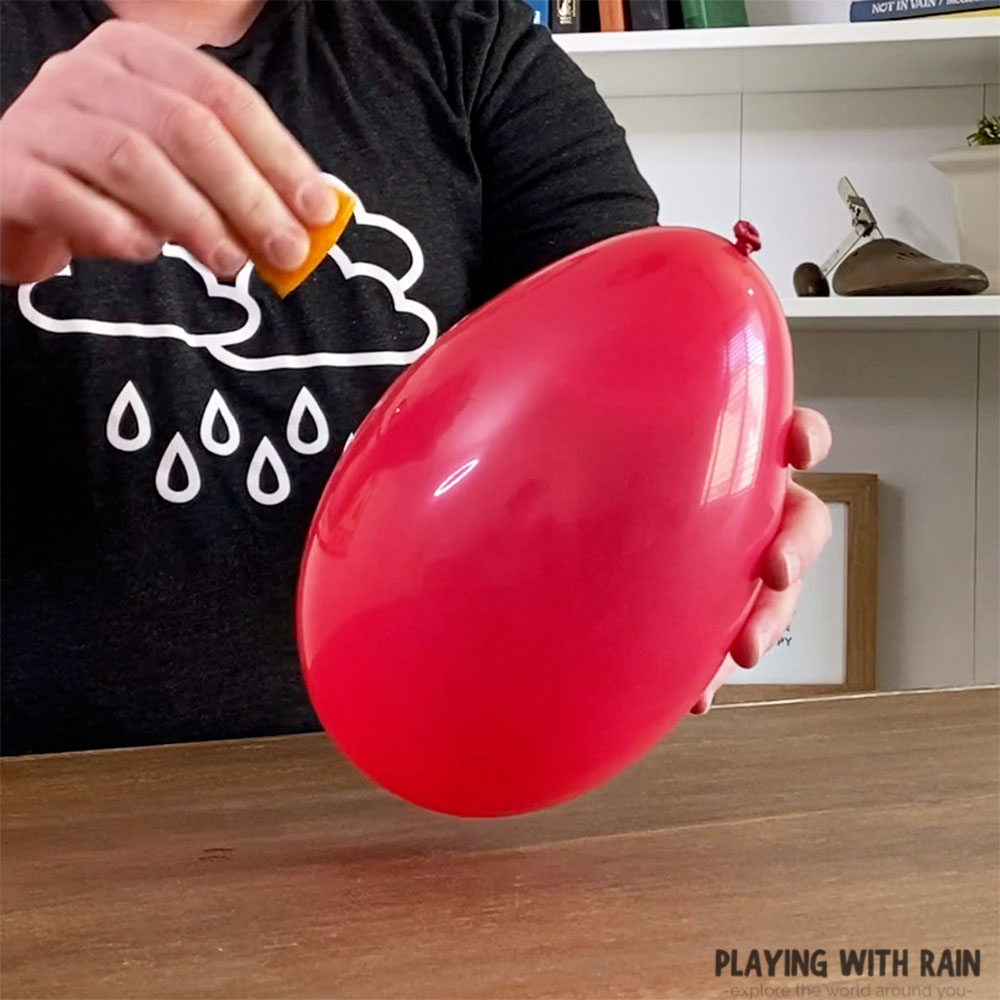 Squeeze the orange juice onto the balloon