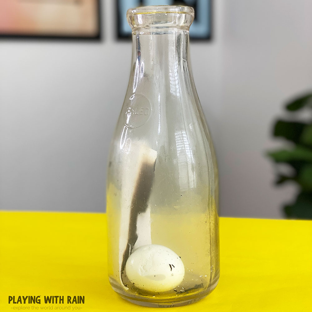 An egg is pushed inside a bottle by air pressure