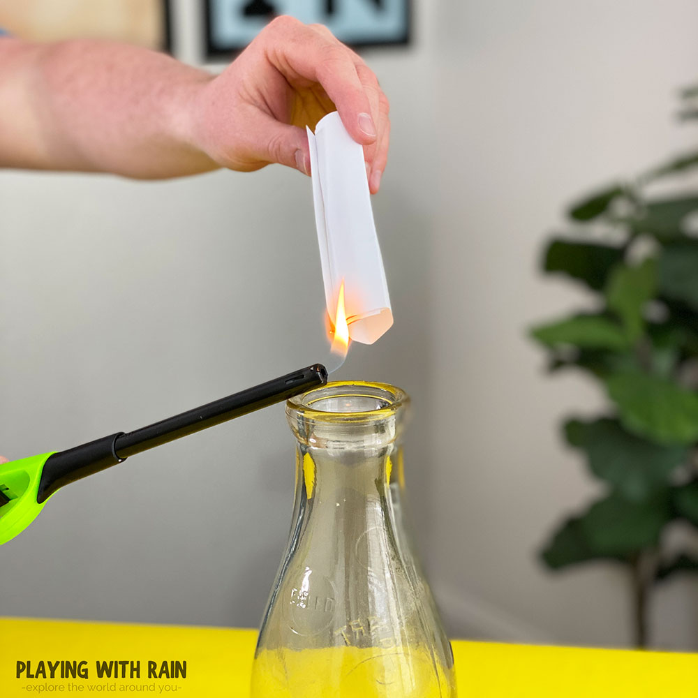 Use a lighter to light the paper on fire