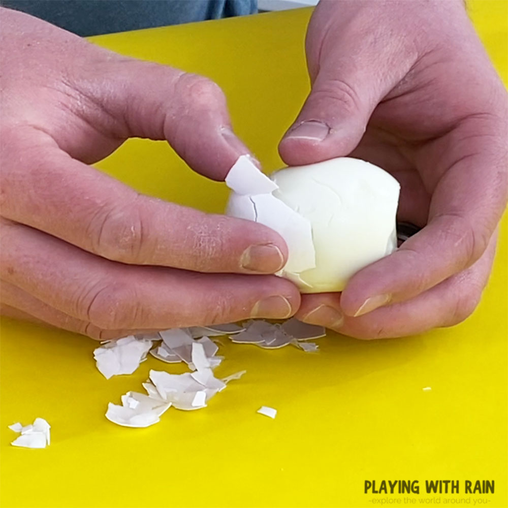 Peel the shell off a hard-boiled egg