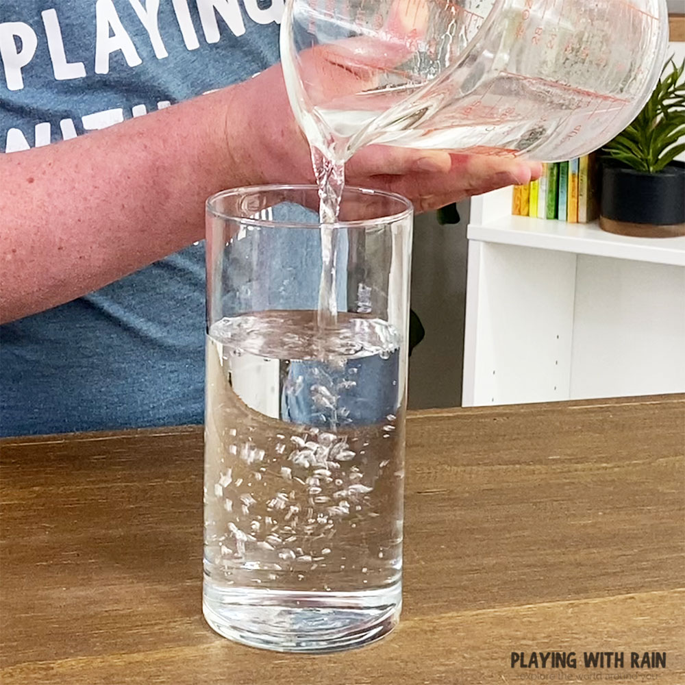 Pour water into a glass cup