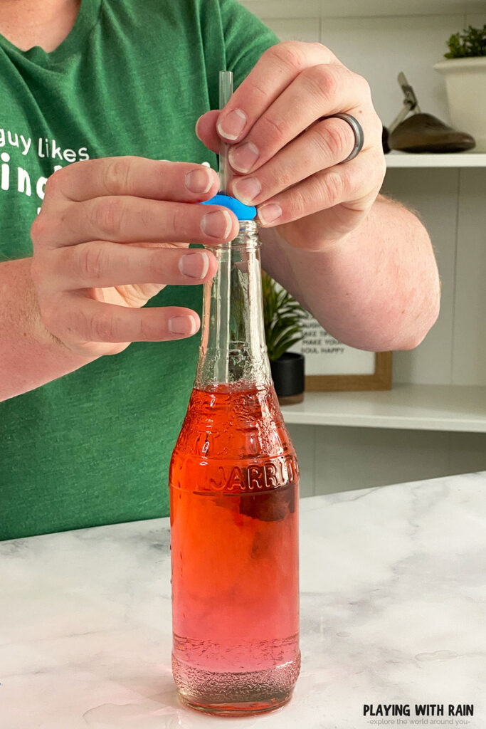 Setting a straw into the bottle