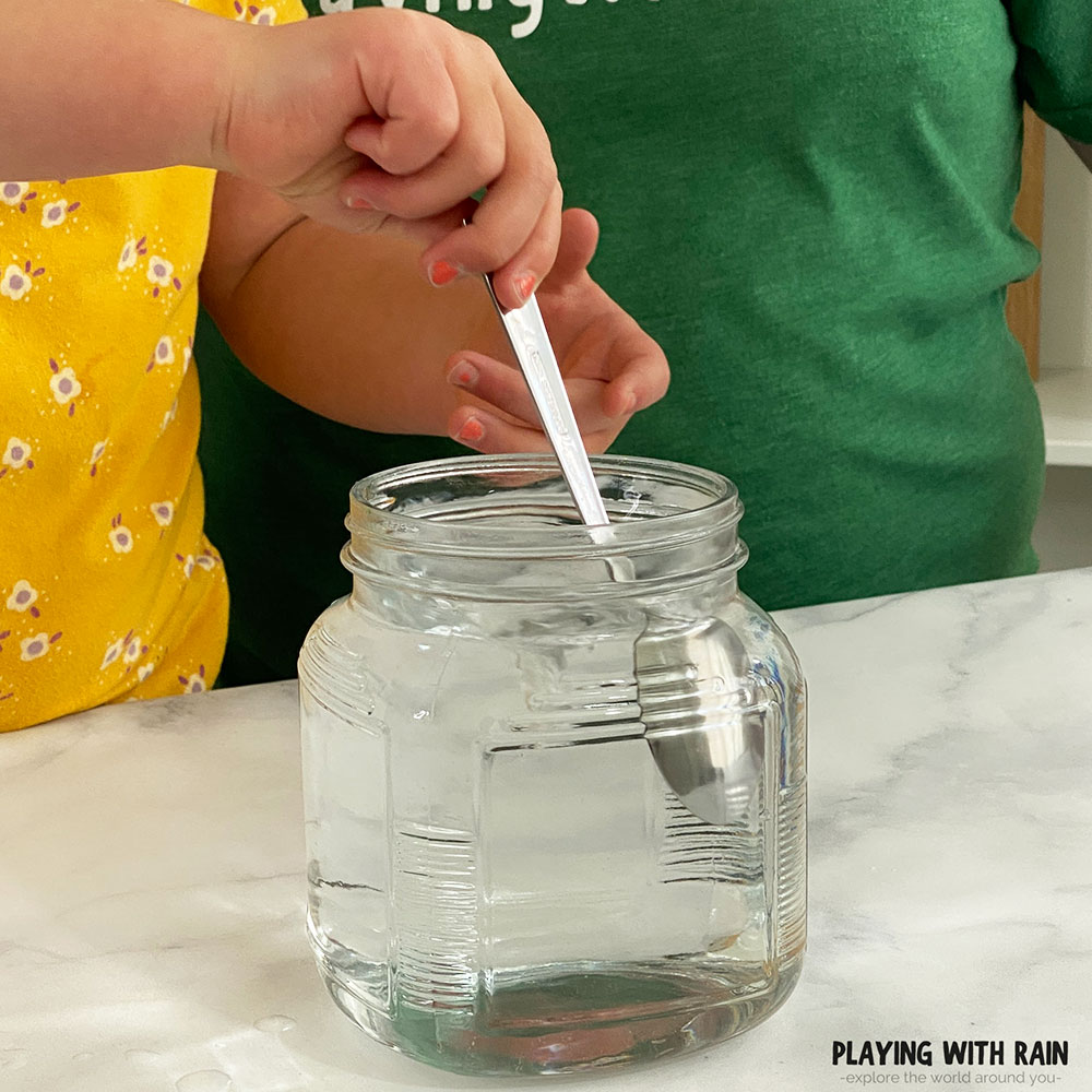 Stir water in a circular motion with a spoon